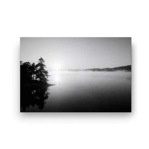 tåkete innsjø i soloppgang på lerret